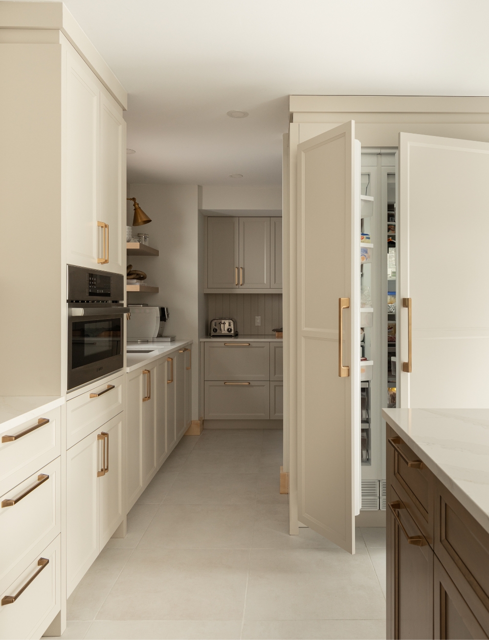 Kitchen with a hidden fridge in cream kitchen cabinet.